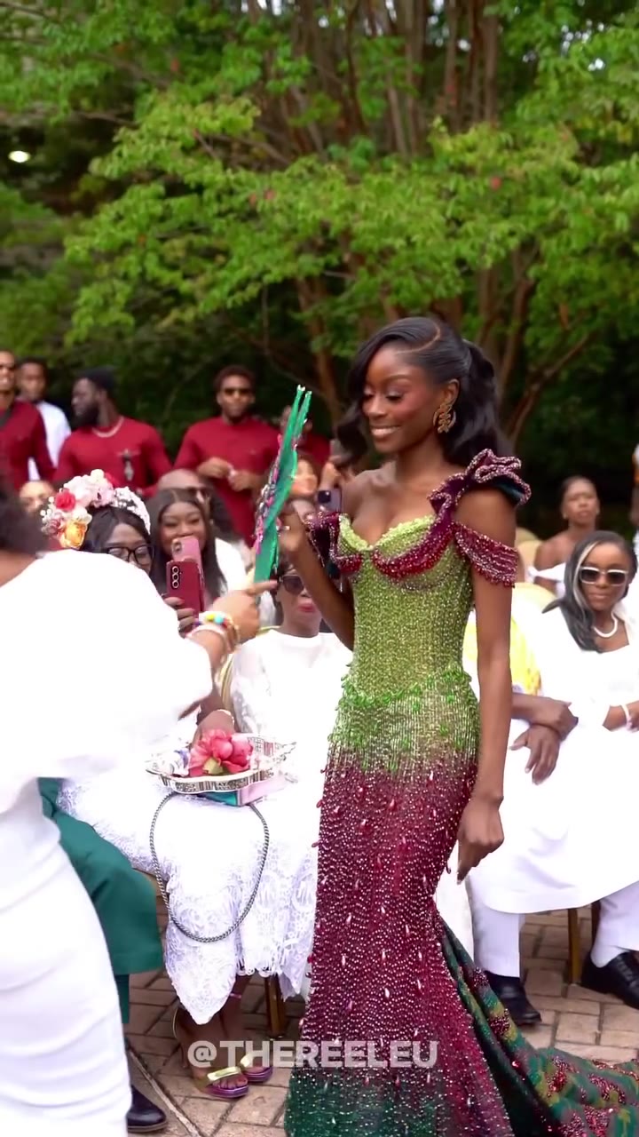 MC Dr Akua speaking into a microphone at a Ghanaian traditional wedding